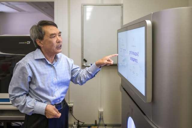 Man pointing at flat computer monitor screen